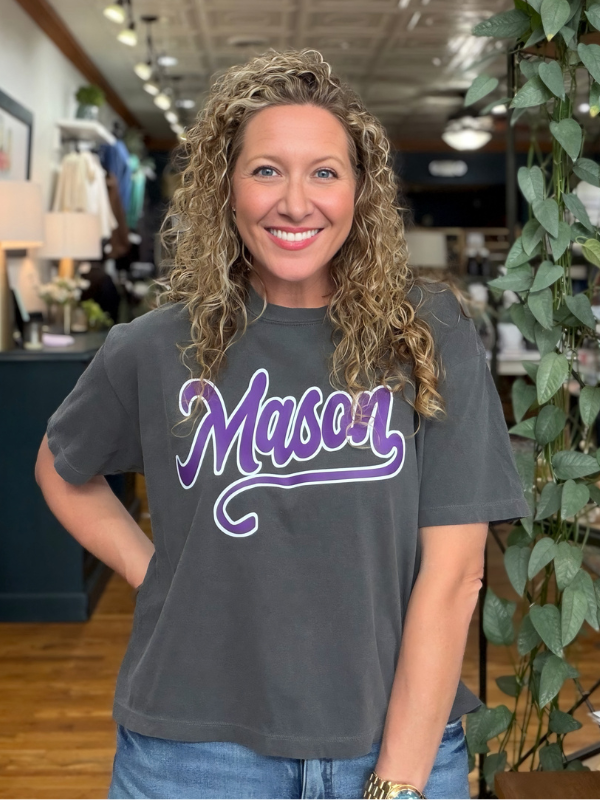 woman wearing a boxy grey tee that says Mason 