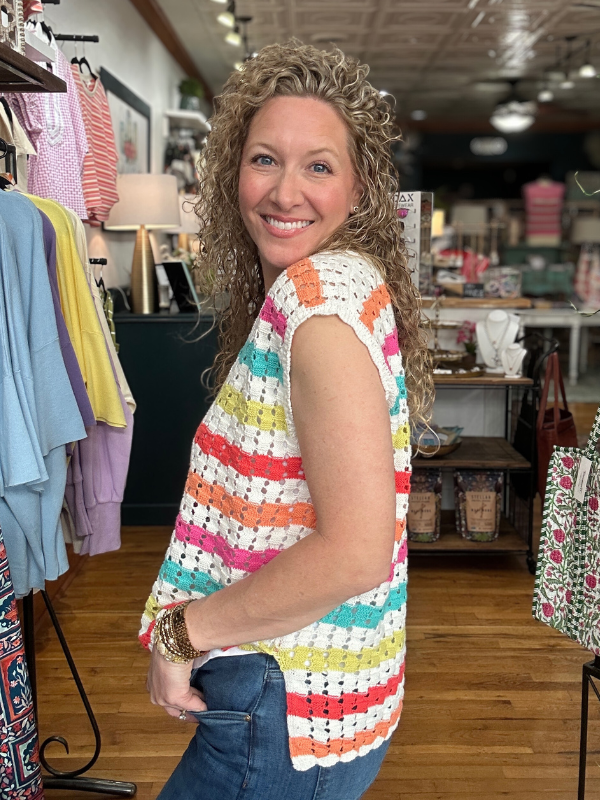 Woman wearing a colorful striped shirt in a store setting