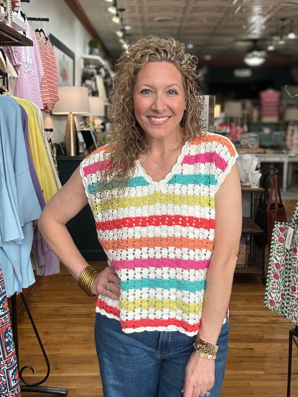 Woman wearing a colorful striped shirt in a clothing store