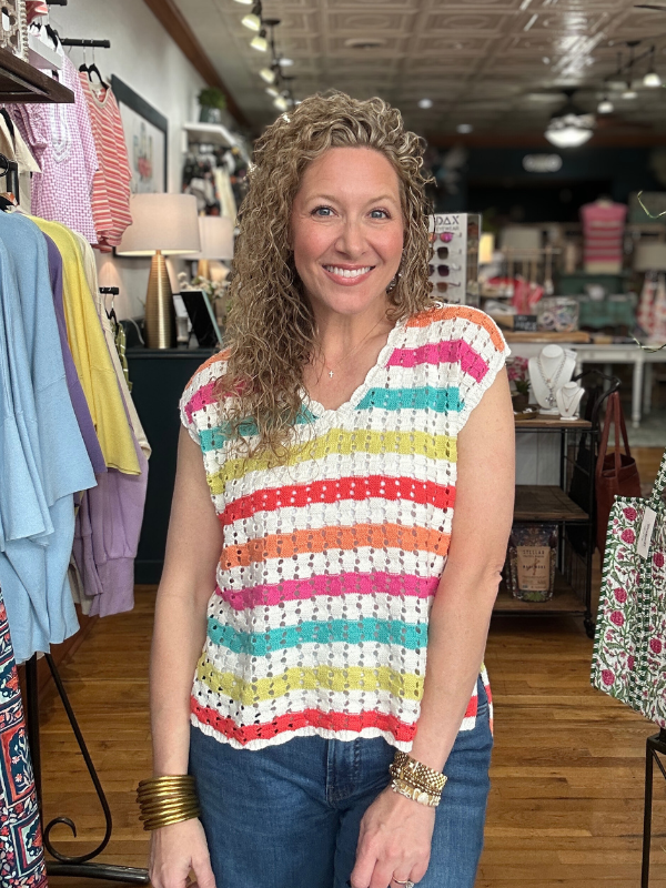 Woman wearing a colorful striped shirt in a clothing store