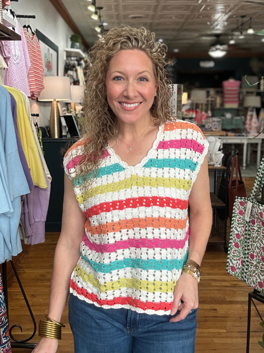 Woman wearing a colorful striped shirt in a store setting