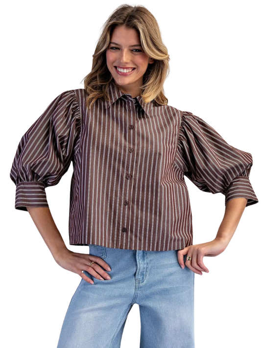 woman wearing a brown and cream striped collared top with jeans