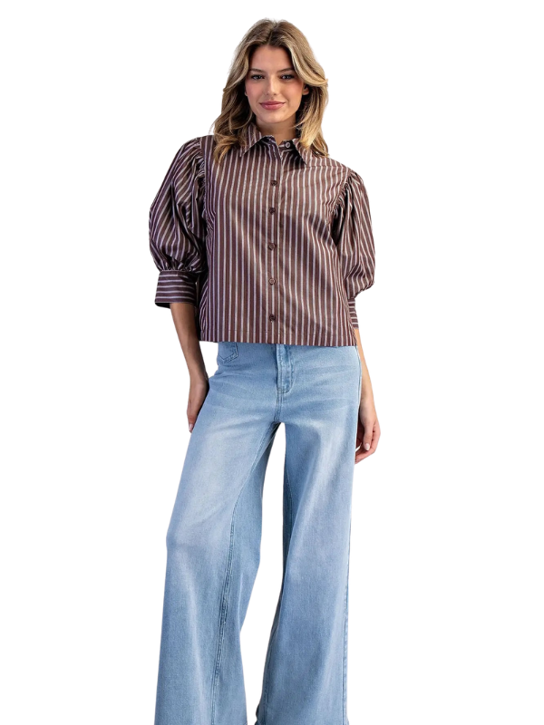 woman wearing a brown and cream striped collared top with jeans