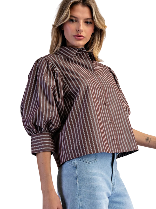 woman wearing a brown and cream striped collared top with jeans