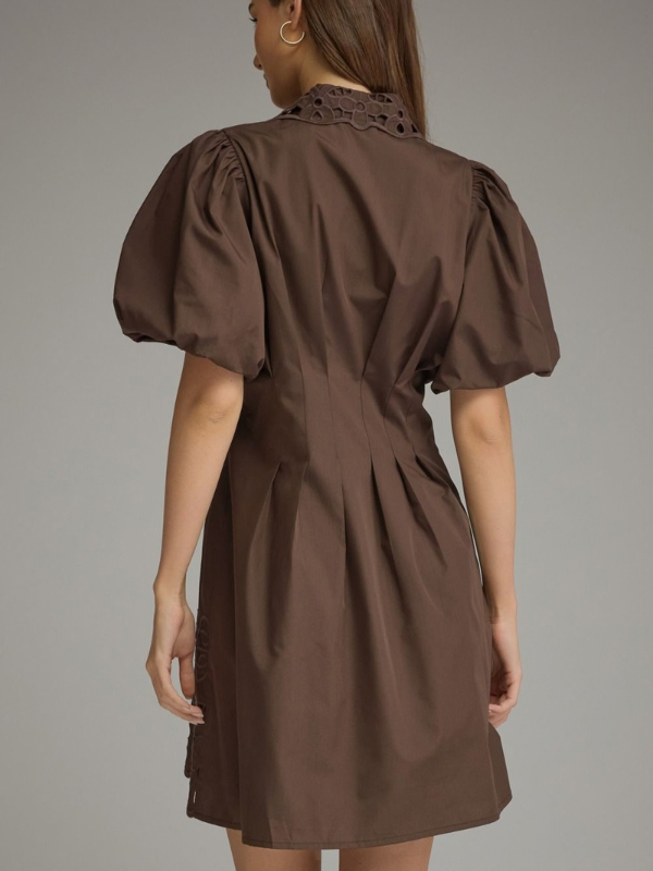 woman wearing a brown eyelet dress 