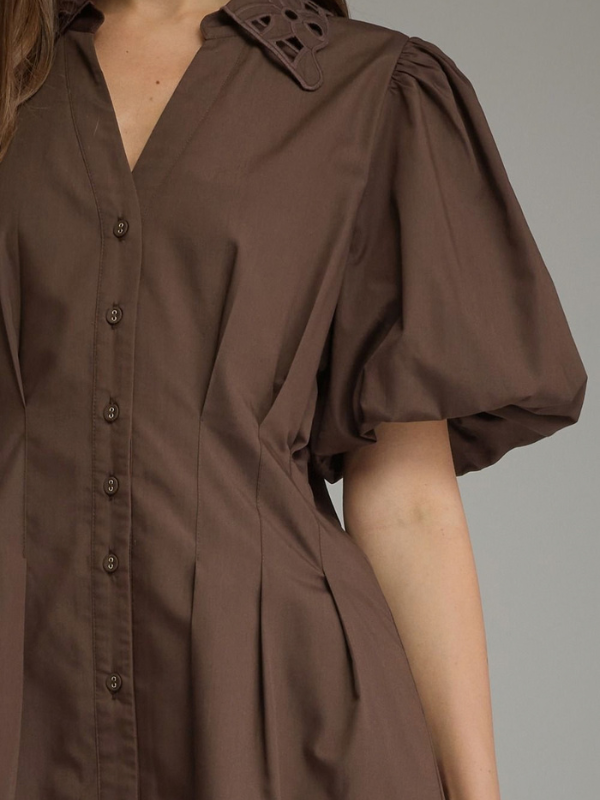 woman wearing a brown eyelet dress 