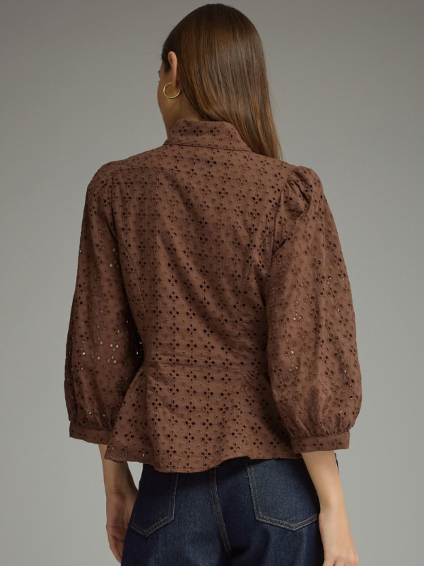 woman wearing a brown eyelet top 