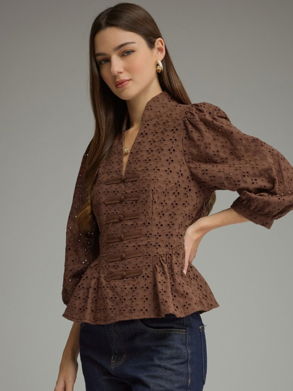 woman wearing a brown eyelet top 