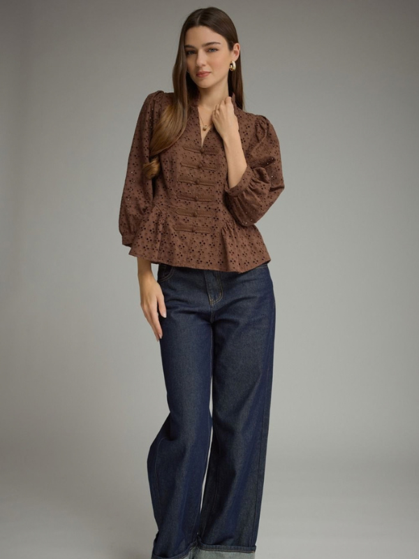 woman wearing a brown eyelet top 