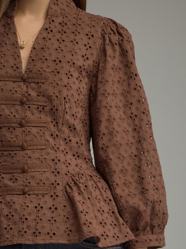 woman wearing a brown eyelet top 