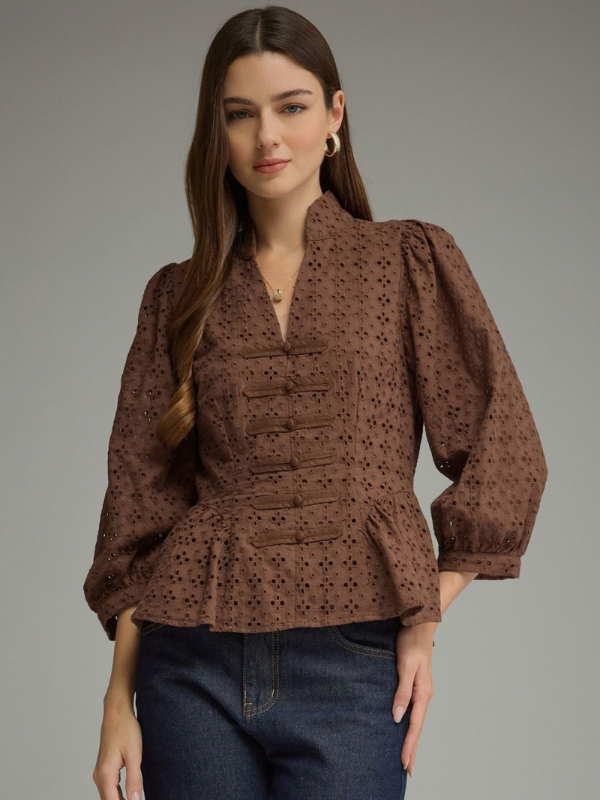 woman wearing a brown eyelet top 
