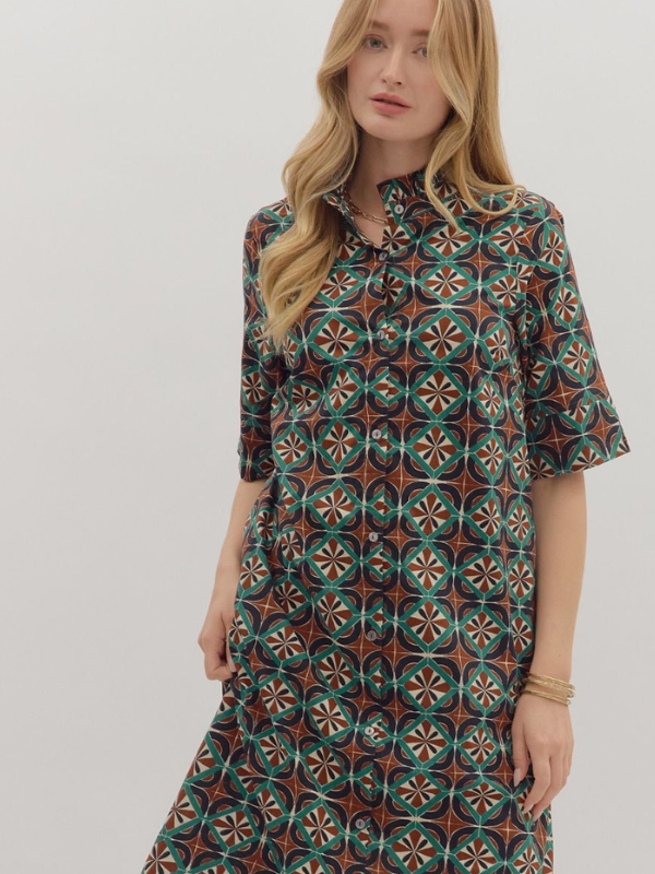 Woman wearing a patterned dress on a plain background