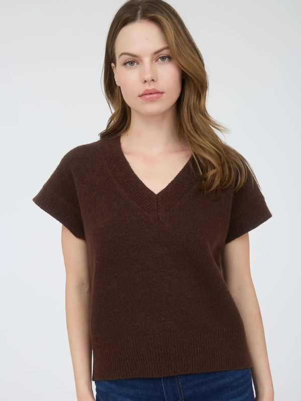 Woman wearing a brown short-sleeve sweater against a white background