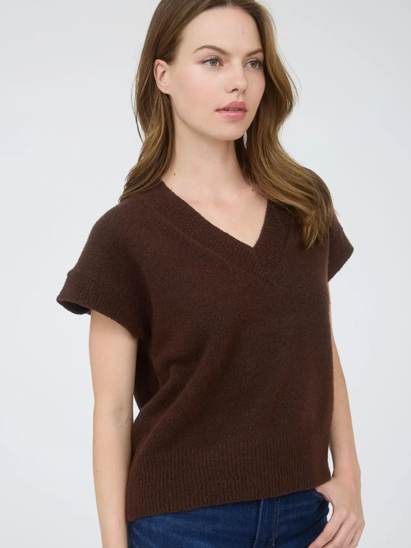 Woman wearing a brown short-sleeve sweater against a white background