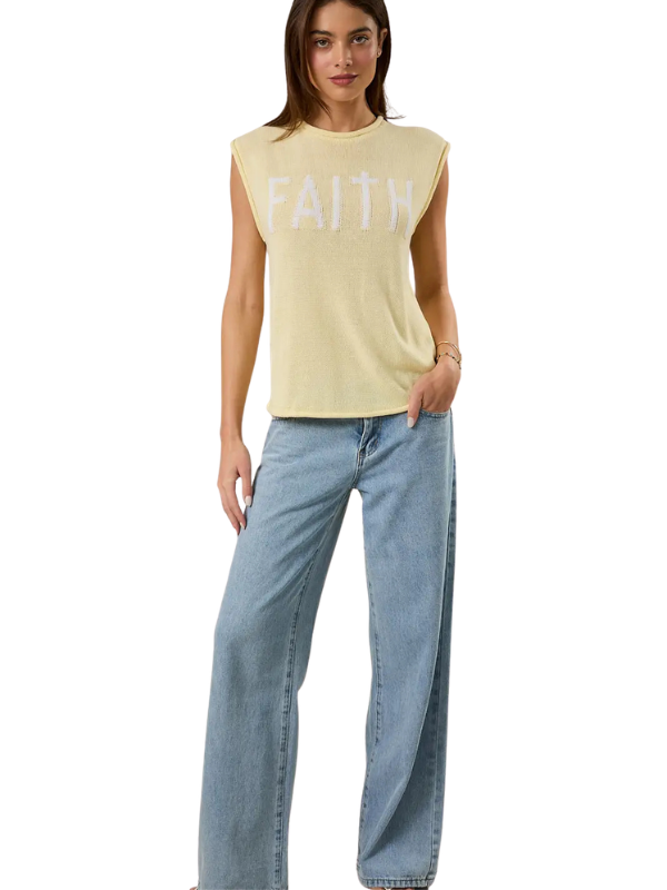 Woman wearing a yellow 'FAITH' tank top and blue jeans on a white background