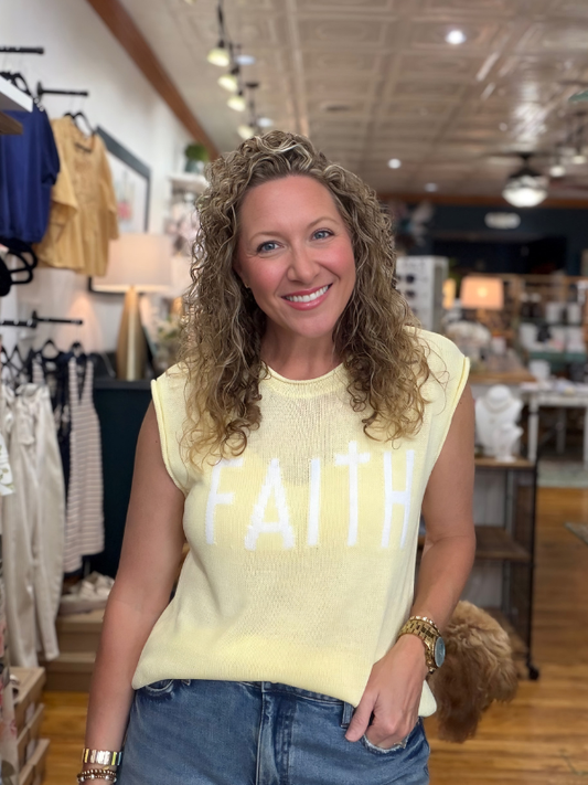 Woman wearing a yellow 'FAITH' shirt in a store setting