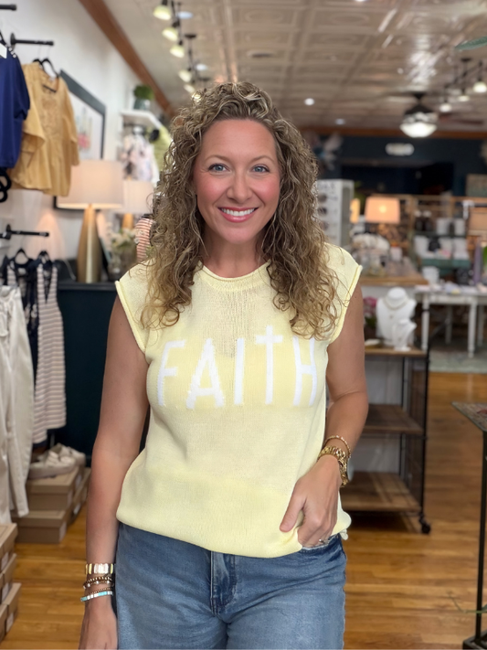 Woman wearing a yellow 'FAITH' shirt in a store setting