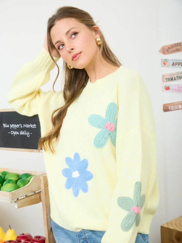 woman wearing yellow sweater with flowers