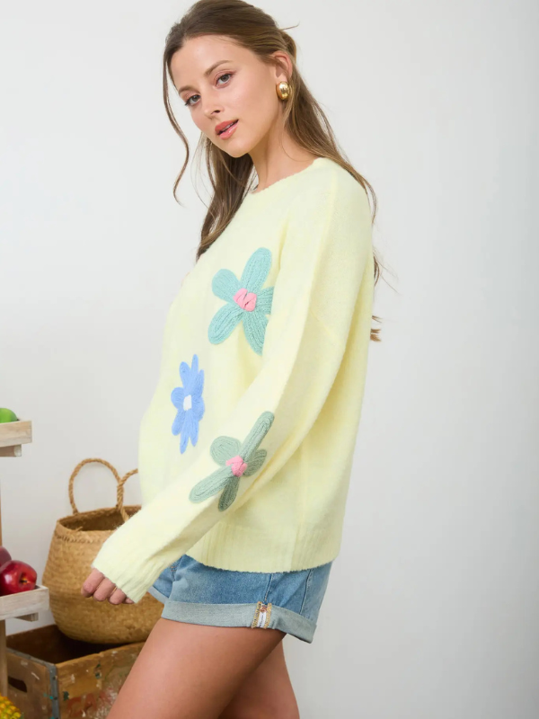 woman wearing yellow sweater with flowers