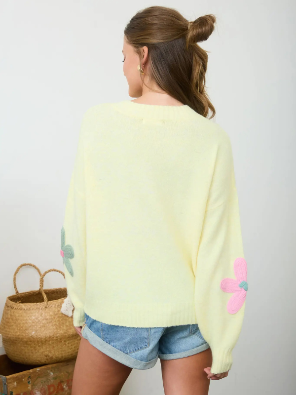 woman wearing yellow sweater with flowers
