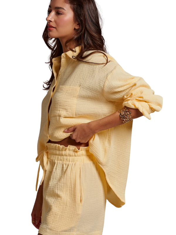 woman wearing butter yellow gauze shorts and matching top 