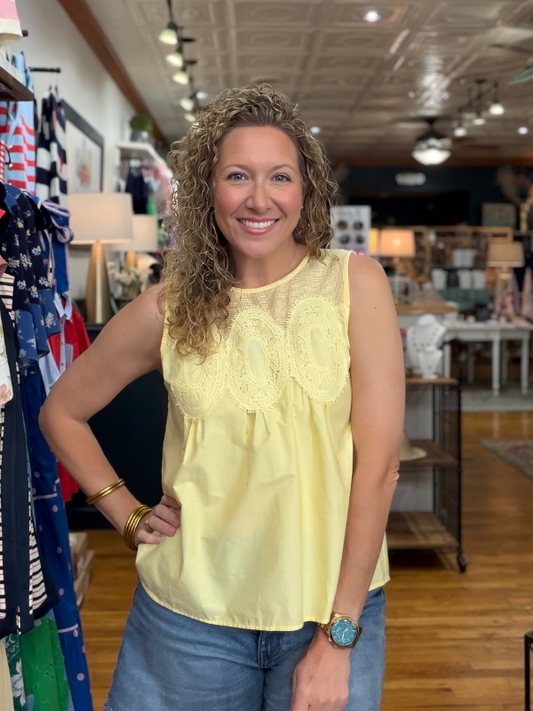 Woman wearing a yellow top in a store setting