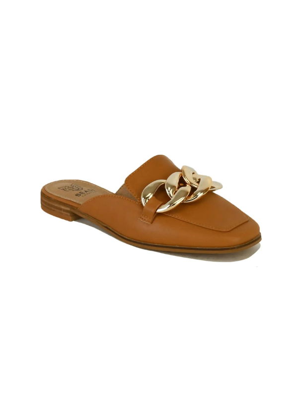 A tan leather mule slide featuring a prominent gold-tone chain detail across the strap, shown on a plain white background.