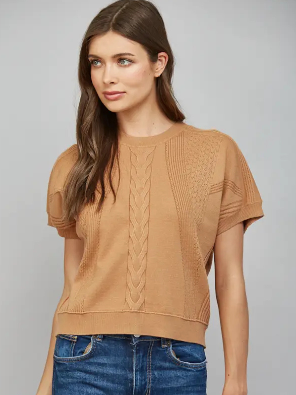 woman wearing a camel short sleeve top with jeans