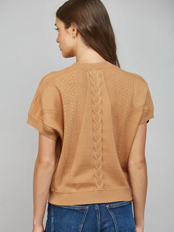 woman wearing a camel short sleeve top with jeans