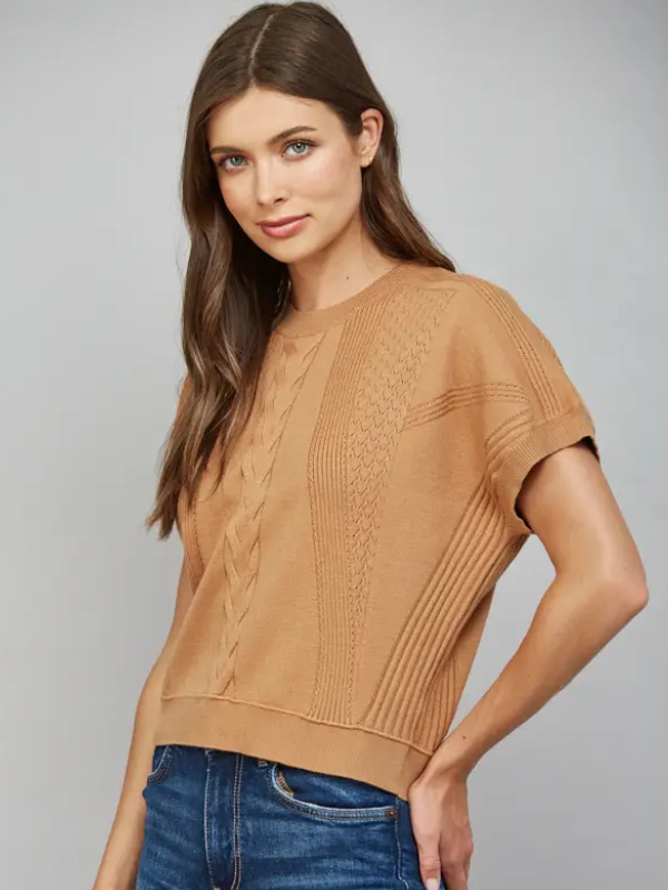 woman wearing a camel short sleeve top with jeans
