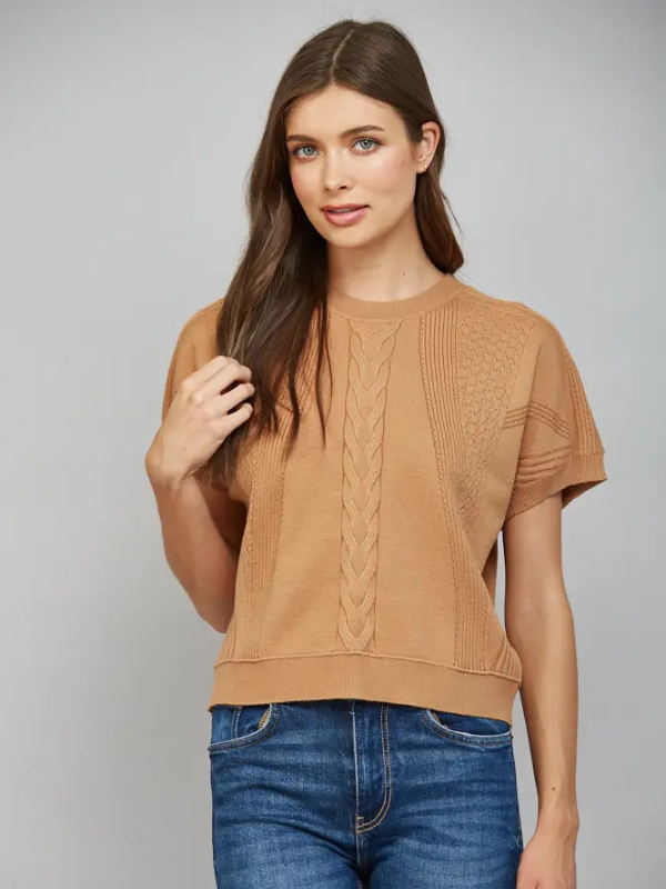 woman wearing a camel short sleeve top with jeans
