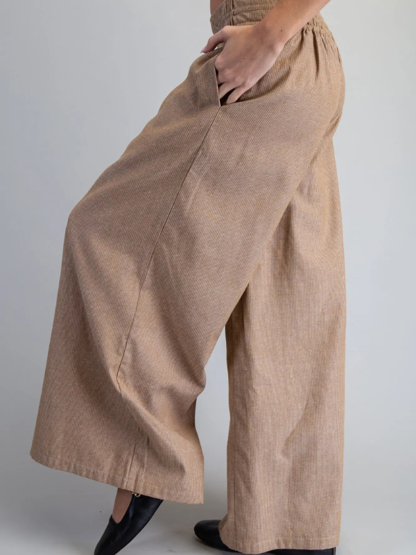 Brown wide-leg pants worn by a person on a plain background