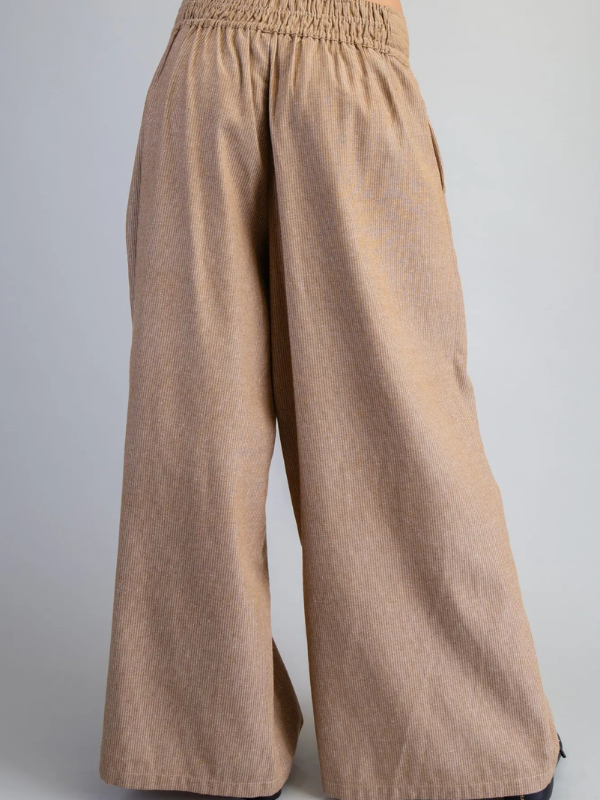 Beige wide-leg pants on a gray background