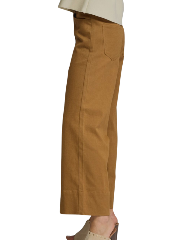 Tan pants worn by a person on a white background