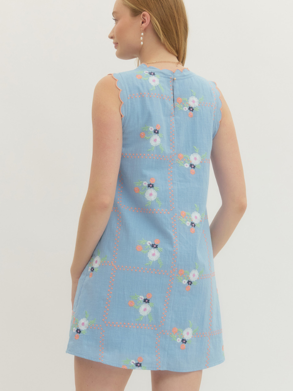 Light blue sleeveless dress with floral embroidery on a white background