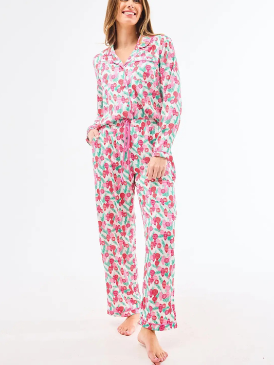 Woman wearing a floral pajama set on a white background