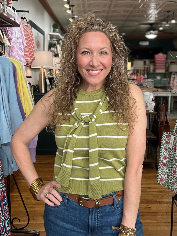 Woman wearing a green striped top in a clothing store