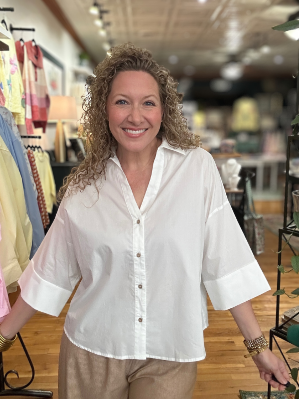 Woman wearing a white blouse in a clothing store