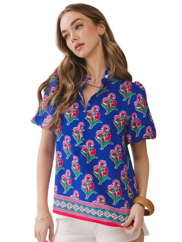 Woman wearing a blue floral patterned blouse on a white background