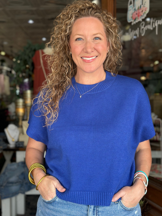 Woman wearing a blue sweater in an indoor setting