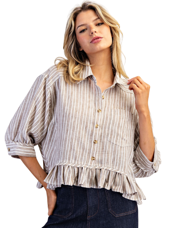 Woman wearing a striped blouse with ruffled details on a white background