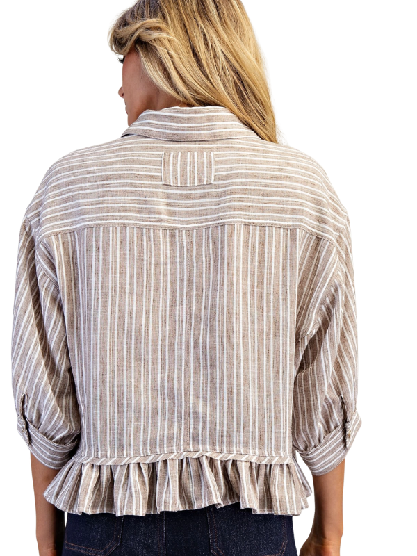 Woman wearing a striped shirt with rolled-up sleeves on a white background