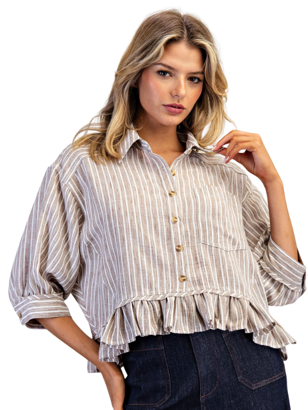 Woman wearing a striped blouse with ruffled details on a white background