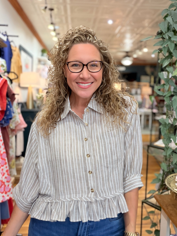 Woman wearing a striped shirt in a store setting