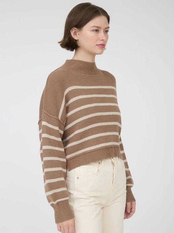 Woman wearing a brown and beige striped sweater on a white background