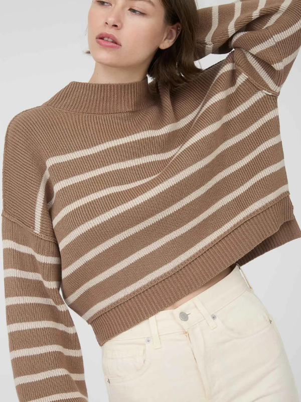 Woman wearing a brown and beige striped sweater against a white background