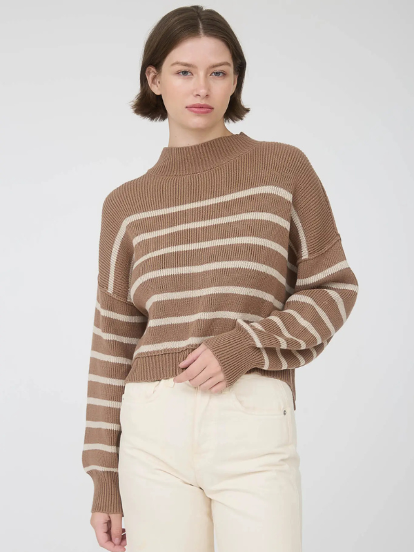 Woman wearing a brown and beige striped sweater against a white background