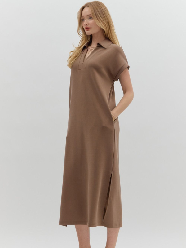 Woman wearing a brown dress with a white background