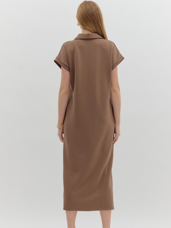 Woman wearing a brown dress on a white background