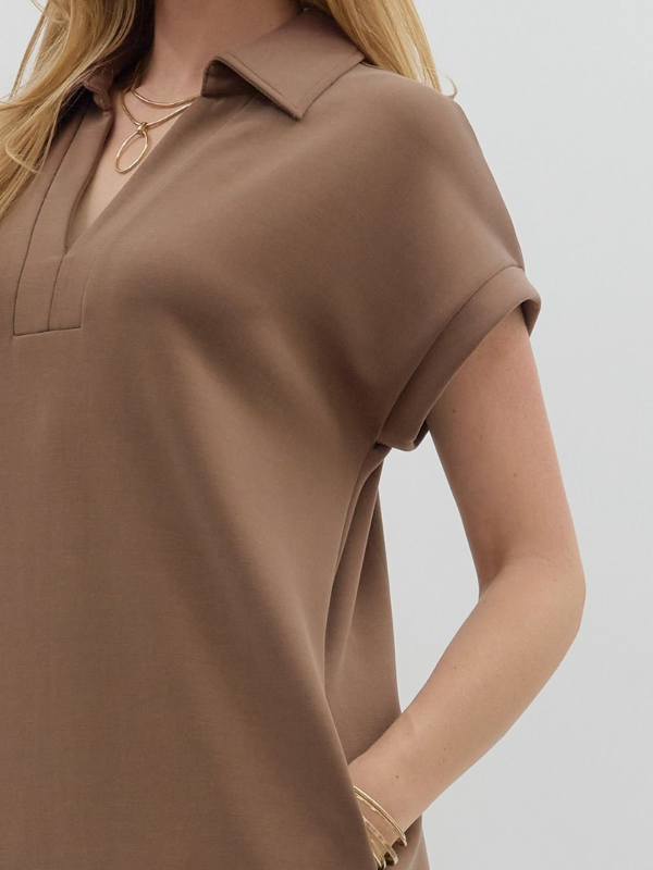 Brown short-sleeve top worn by a person on a light gray background